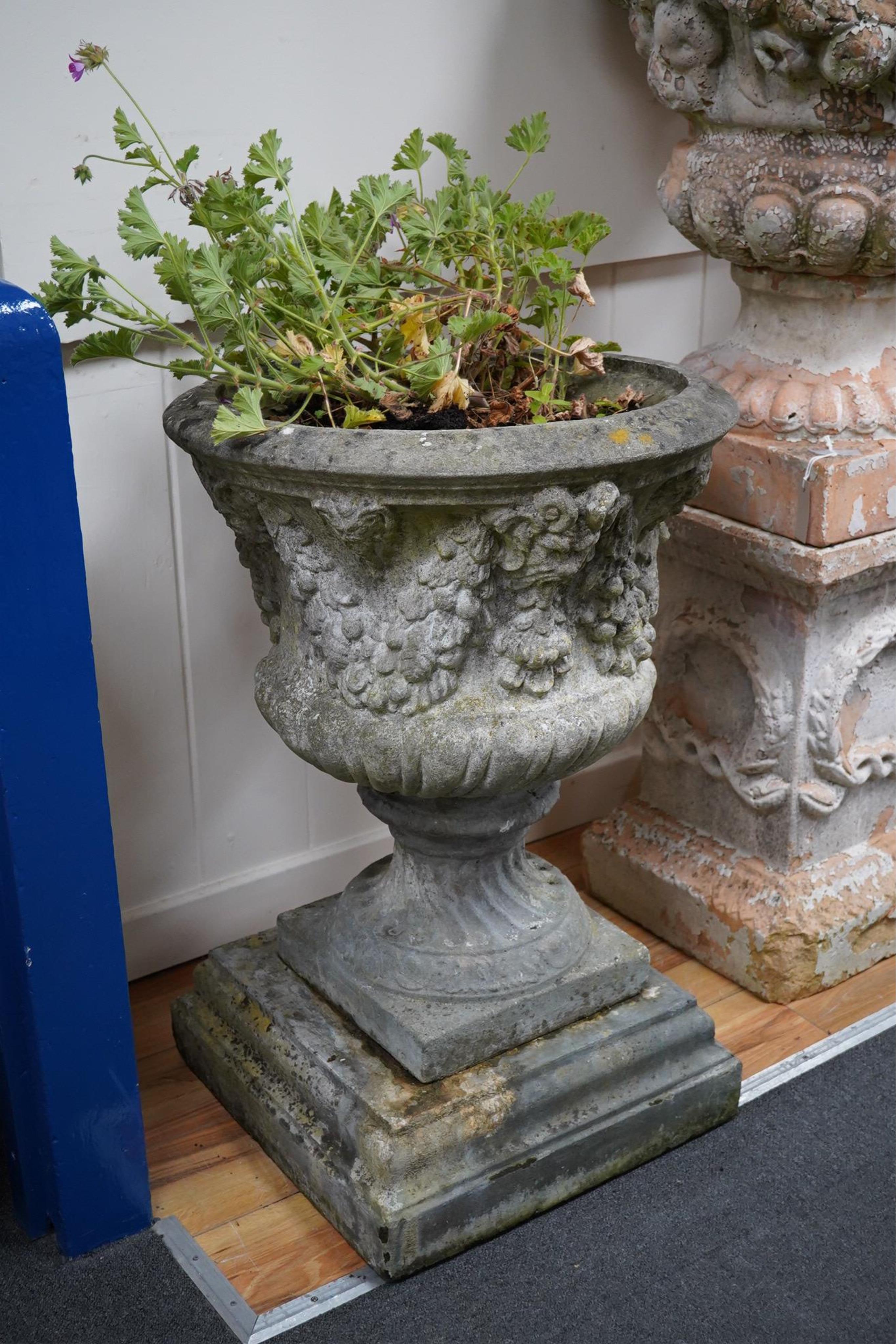 Three reconstituted stone campana shaped garden urns